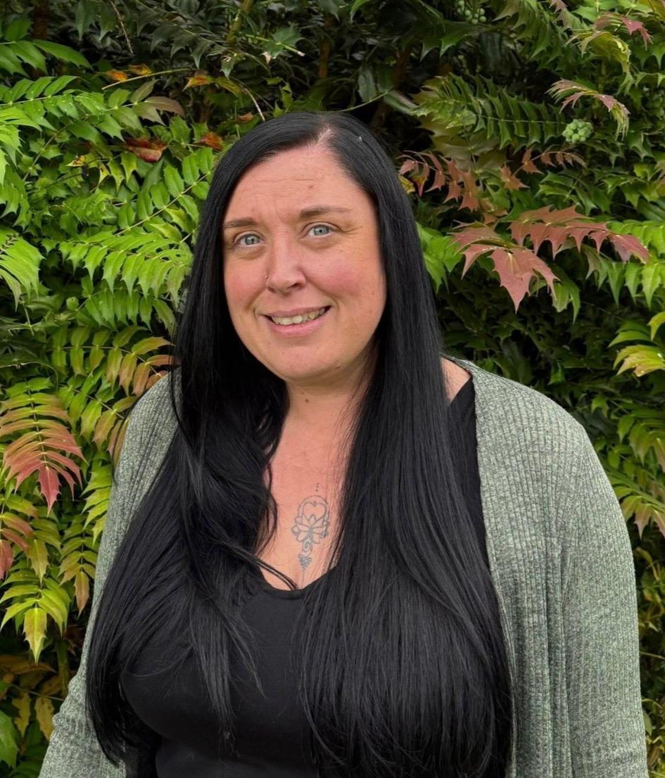 woman with long black hair standing outside