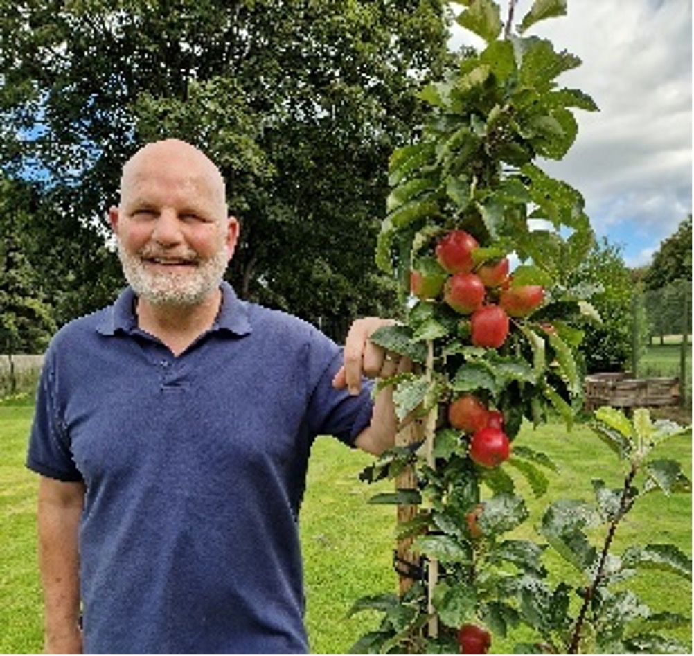 Manor Grange Gardener Standing Next to Apple Tree