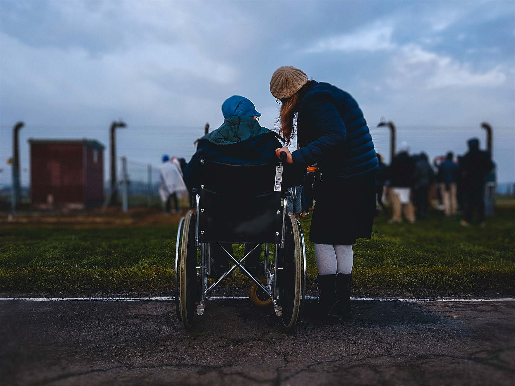 Person in wheelchair outside with carer