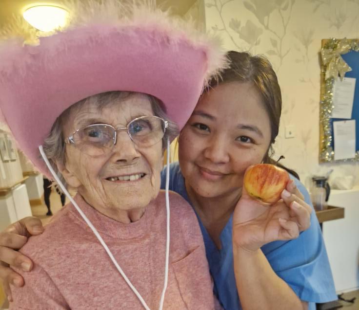 resident and staff member smiling