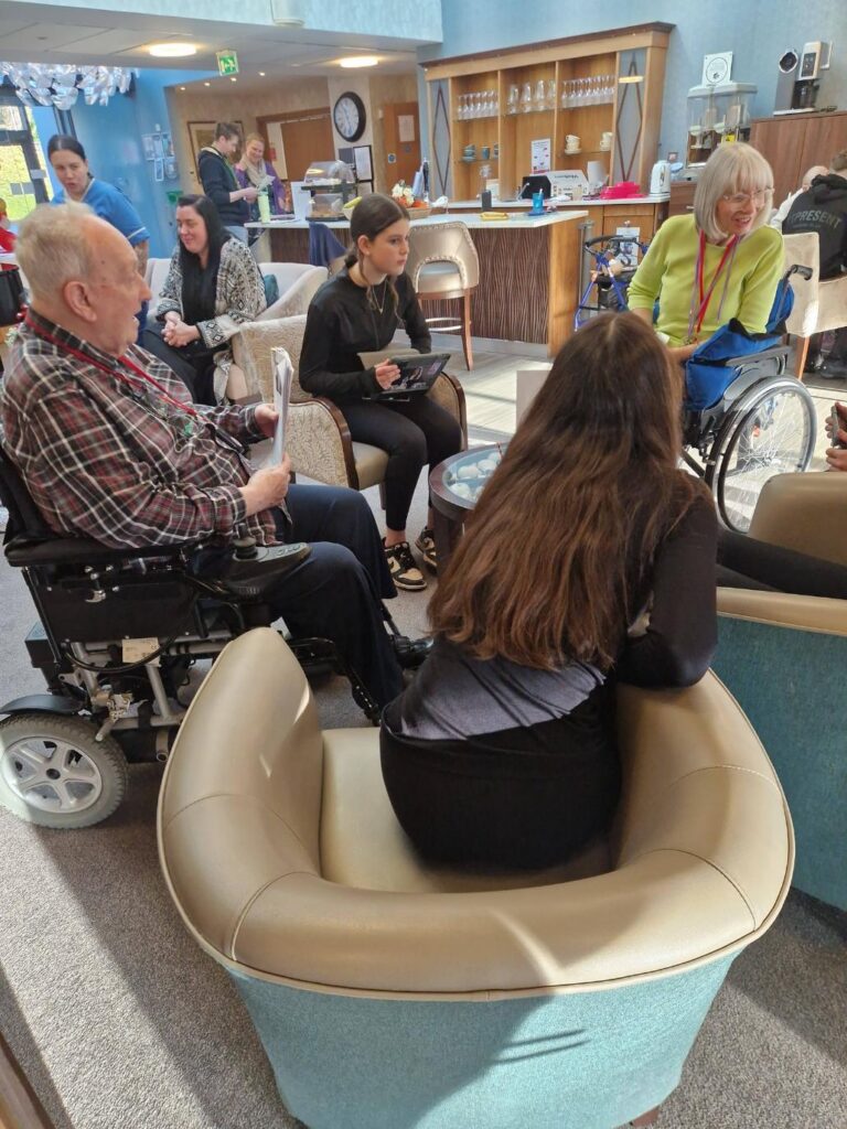 children chatting with care home residents