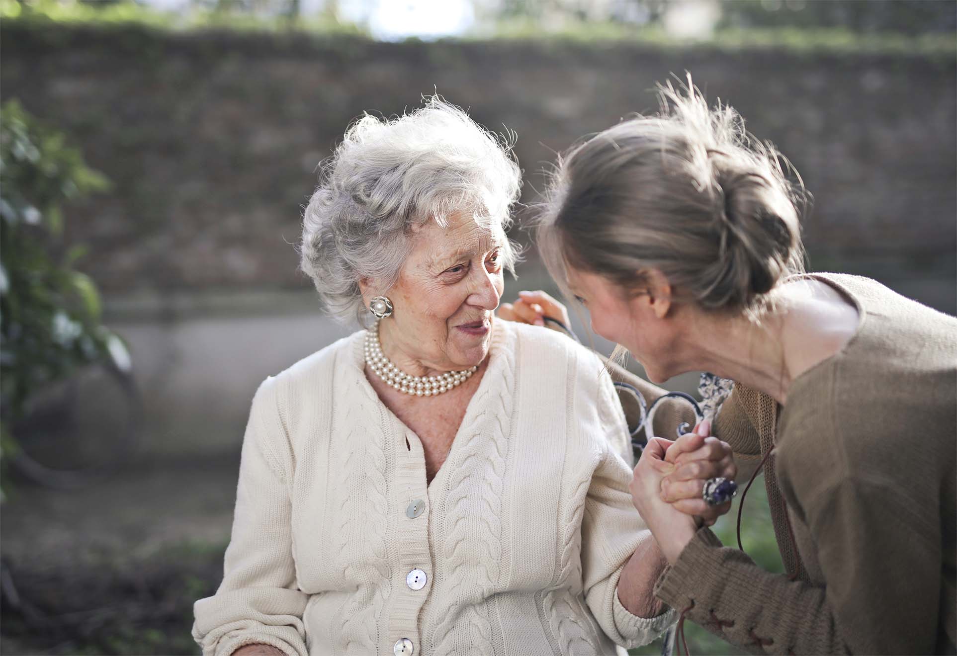 elderly woman smiling with care worker
