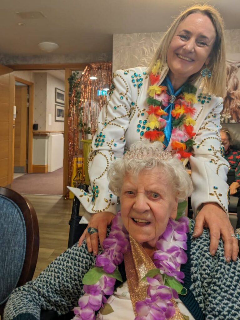 two ladies smiling at a birthday celebration