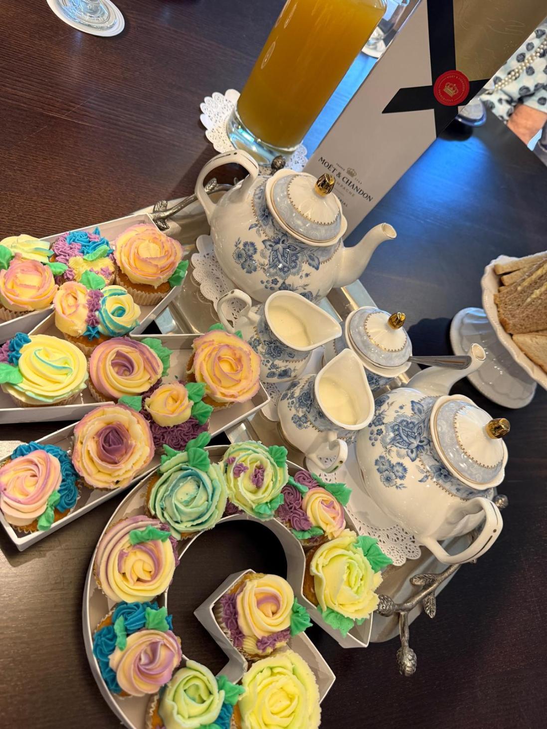 afternoon tea spread with decorated cupcakes